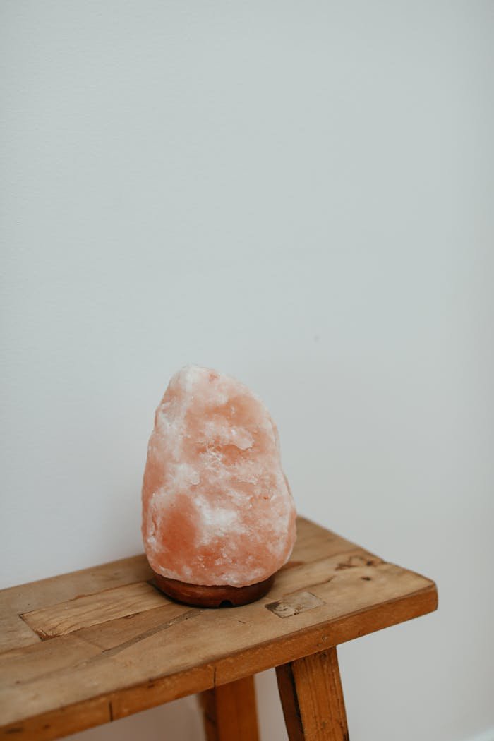 A serene Himalayan salt lamp on a wooden bench, promoting relaxation and wellness.